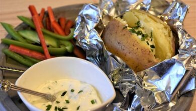 juicy-steak-with-crispy-baked-potato-on-wooden-plate