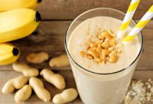 Creamy-peanut-butter-banana-smoothie-in-a-glass-with-a-straw